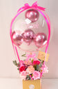 Pink flowers with balloons in box