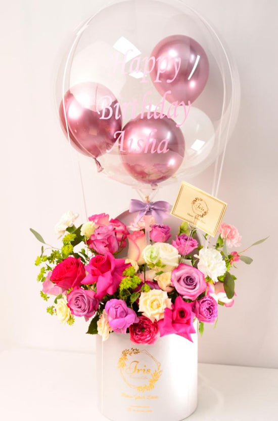 Pink flowers box with balloons