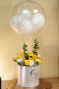 Yellow flowers with balloon in box