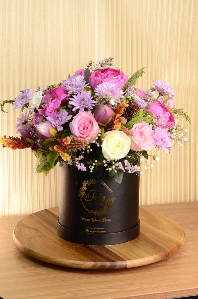 Pink artificial and fresh flowers box