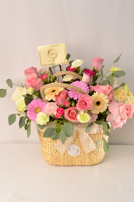 Pink and white flowers in hand bag