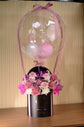 Pink flowers with balloon in box