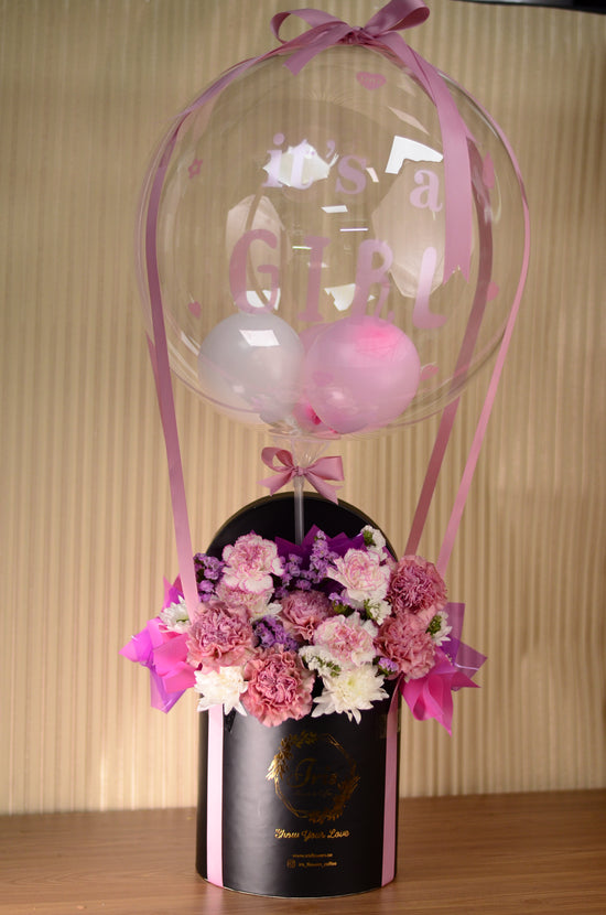 Pink flowers with balloon in box