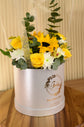 Yellow flowers with balloon in box