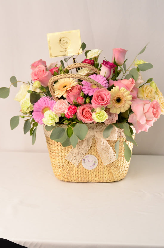 Pink and white flowers in hand bag