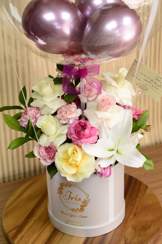 Pink and white rose with balloons in box